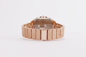 Detailed close-up of rose gold square watch with crystal pavé and screw motif band