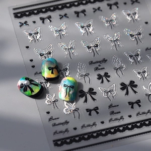 Holographic silver butterfly and bow nail art stickers with black outlines and 3D pearls