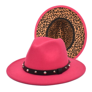 Close-up of hot pink wool fedora with leopard print brim underside and studded leather band