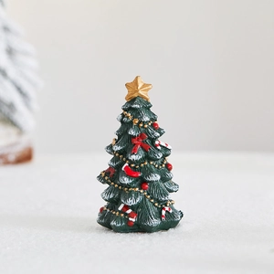 Mini resin Christmas tree figurine with snow effect, gold star, and red ribbon decor