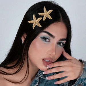 Retro golden starfish hair clips for women with a minimalist metallic textured finish