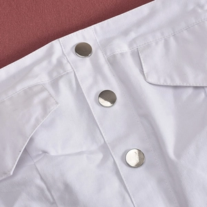Detail of white tube top outfit showing silver metal buttons and symmetrical pockets
