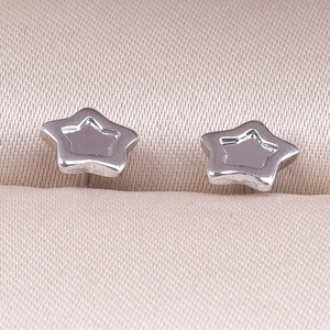 Macro shot of silver star-shaped 304 stainless steel stud earrings on pink satin