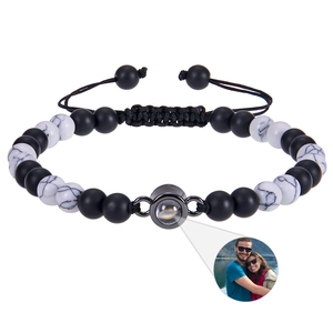 Macro detail of customized photo projection bracelet with zebra stone and matte black beads