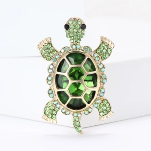 Golden turtle brooch with large green faceted crystals and sparkling rhinestone accents