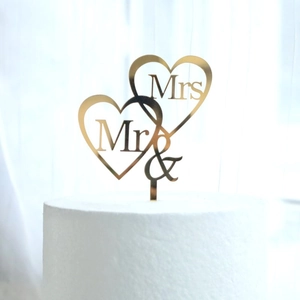 Detail of gold mirror acrylic Mr & Mrs double heart wedding cake topper on white cake