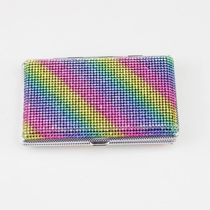 Macro detail of rainbow rhinestone cigarette case with shiny metallic frame and clasp