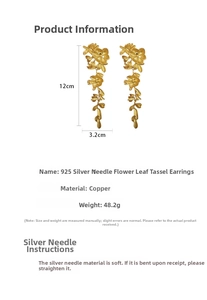 Detail view of long tassel earrings with flower and leaf design in matte gold metal