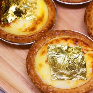 Edible gold foil flakes for cake decoration and DIY baking mousse topping in a jar