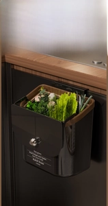 Detail of 12.2L grey hanging kitchen bin with wood grain trim and gold spherical handle