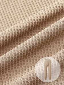 Detailed close-up of waffle knit texture and drawstring on men's khaki leisure pants
