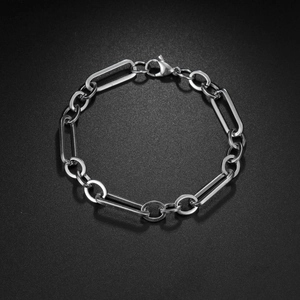 Polished silver stainless steel Figaro chain bracelet with lobster clasp on black background