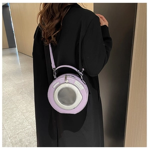 Detail of vintage camera shaped purple PU leather bag with silver lens decoration