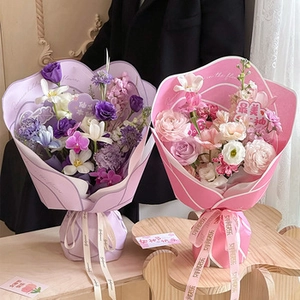 Detail of pink and purple floral bouquets with elegant fringed snow yarn ribbon and wrapping