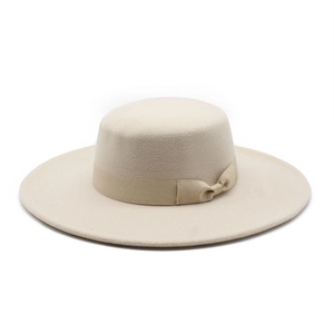 Close-up of cream flat-top wool felt hat with khaki ribbon bow and wide brim detail