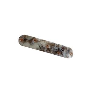 Elegant marble pattern hair clip with small orange flowers on a clean white background