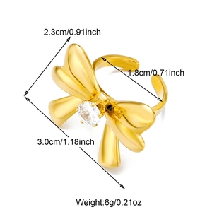 Detailed dimensions of gold bow ring with shell flower and crystal in studio view