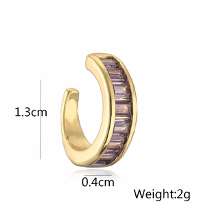 Macro detail of 18K gold plated ear cuff with purple baguette-cut cubic zirconia gems
