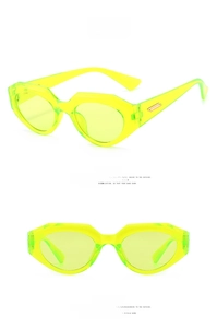 Detail of neon green irregular cat-eye sunglasses with gold metal bar on temple