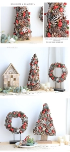 Close-up of pine cone Christmas tree and wreath with red berries and snow detail