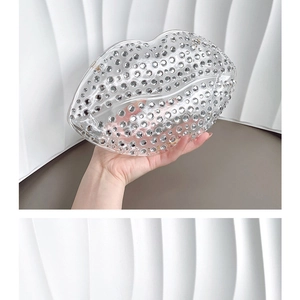 Detail of lip-shaped evening bag featuring sparkling silver rhinestones and transparent finish