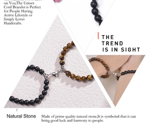 Close-up of heart magnet clasp and natural tiger eye stone beads on couple bracelets