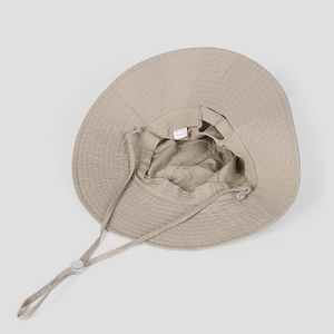 Detail of khaki outdoor bucket hat showing cotton nylon fabric texture and chin strap