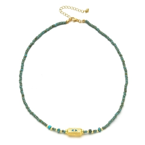 Detail of turquoise beaded necklace with gold Evil Eye charm and adjustable lobster clasp