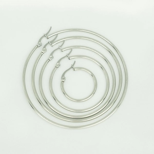 Detailed top view of five different sizes of polished stainless steel hoop earrings