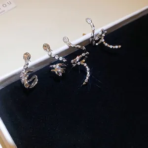 Silver snake stud earrings with brilliant zircon stones on black velvet display