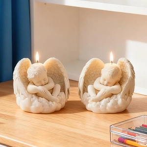 Detailed sleeping angel baby scented candles on cloud base with warm flame effect