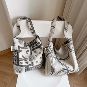 Detailed close-up of paisley pattern and geometric lines on cotton linen tote bag