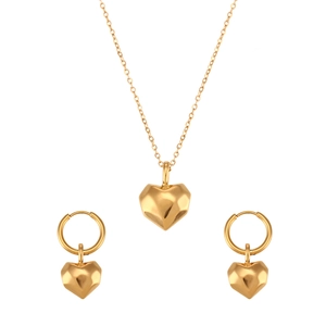 Golden stainless steel heart pendant necklace and earrings set with faceted surfaces