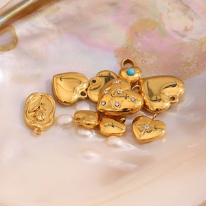 Detailed macro shot of 18K gold plated heart and rose charms for DIY jewelry making