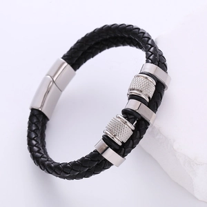Close-up of black braided leather men's bracelet with silver knurled metal beads