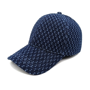 Detail of dark blue distressed denim baseball cap with vintage ripped texture and curved brim