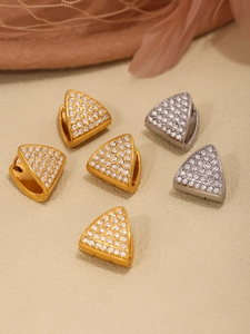 Detailed macro view of triangle hoop earrings with pave-set cubic zirconia in gold and silver