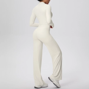 Side view of white three-piece yoga set with zip jacket, vest and wide leg pants