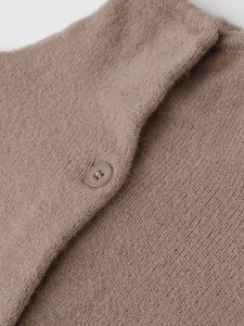 Detail of coffee brown knit cardigan featuring a high neck and matching button texture