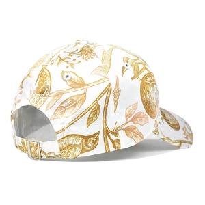 White baseball cap with brown floral bird print and adjustable metal back buckle detail