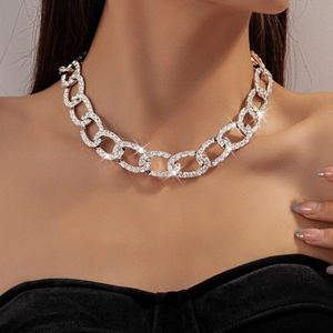 Detail of a sparkling silver rhinestone chain necklace worn by a fashion model