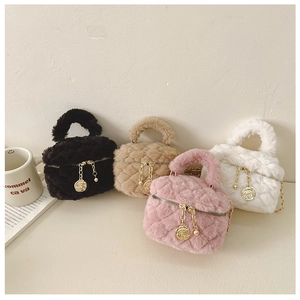 Detailed view of four colorful plush quilted handbags with rose metal zipper pendants