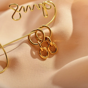 Modern gold-tone stainless steel hoop earrings with interlocking oval link pendants