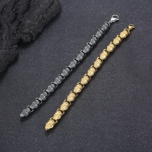 Detailed macro view of punk skull link bracelets in gold and silver stainless steel finish