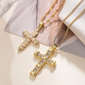 Gold plated cross necklaces with sparkling zircon inlay on elegant textured background