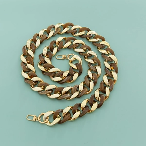Detailed macro view of wide resin acrylic bag chain with gold lobster clasps and connectors