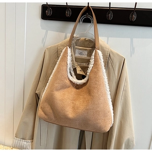 Close-up of brown suede tote bag featuring contrast white plush trim and soft texture