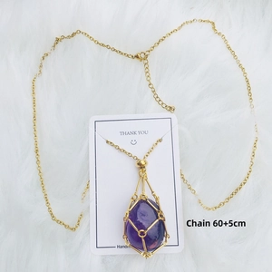 Detail of 60+5cm golden chain with purple crystal teardrop in a woven metal pouch