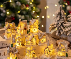 Macro detail of glowing resin Christmas village house with warm LED light and snow finish