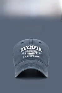 Detail of vintage washed baseball cap featuring white 3D embroidery and worn-out finish